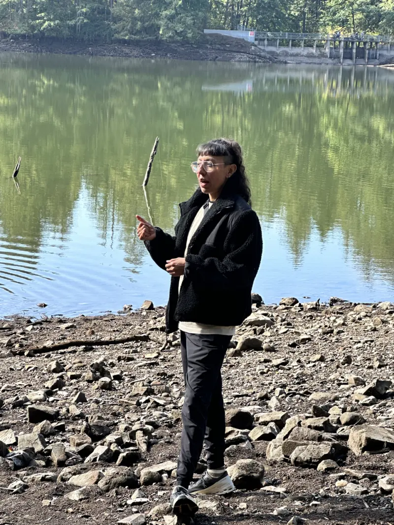 Zulma guiding a forest bathing session beside a lake