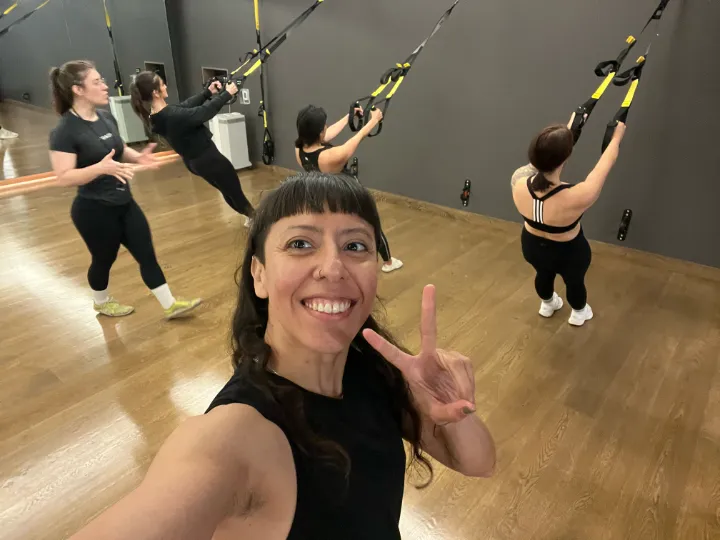 For Individuals & Leaders 4 Zulma smiling during a TRX strength class