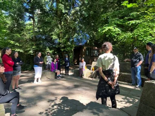Participants gathered in a circle during a forest hike